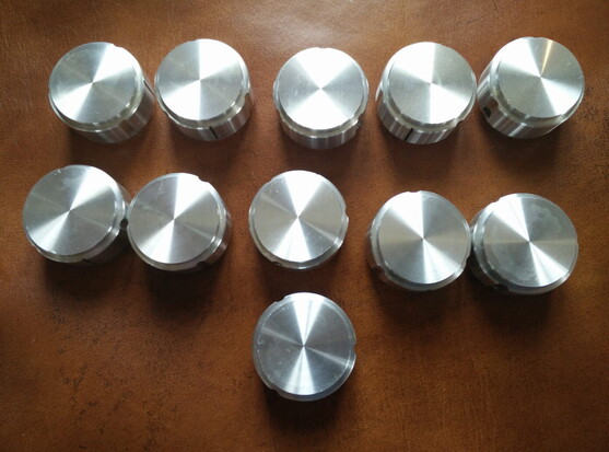 11 spun aluminium control knobs off an amplifier.  Mostly shiny.