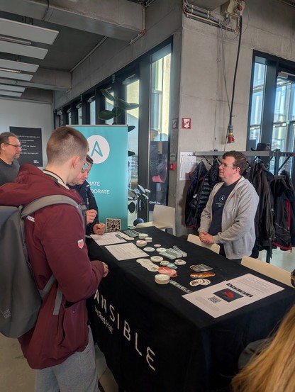 People around the Ansible booth 