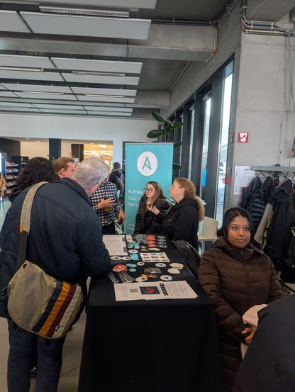 People around the Ansible booth 