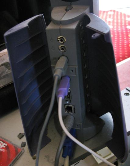 The back of a Sun Javastation Krups with it's doors open, showing the audio jacks, Mini DINs for power, mouse and keyboard, LAN and VGA.
