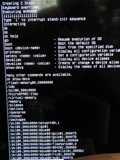 A serial console photo, showing a Javastation openbootprom 'ok' prompt and help and 'show-devs' output.  It's a boring white on black text.