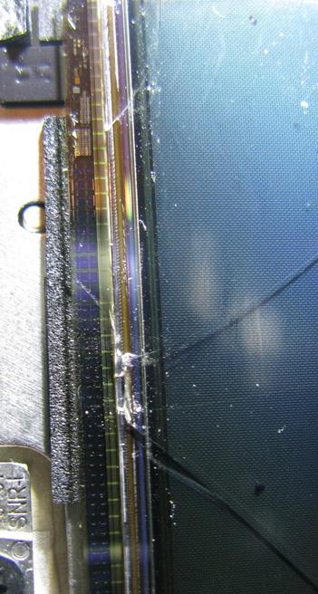 A close up of a display panel; cracks from the panel cross into the connection area at the bottom.  Which probably explains why it's dead.