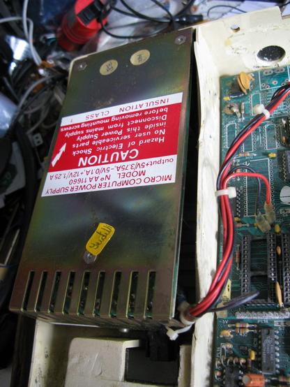 Inside a BBC Model B computer, looking at the PSU; teh blastic next to it is bent away
