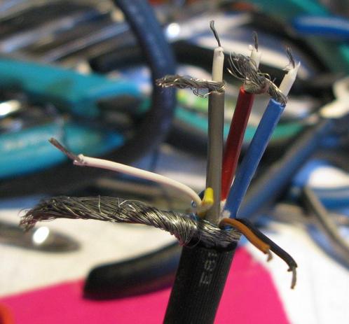 Three coax cables within a VGA cable, there's a red one, a blue one, and a *grey* one - hmm.  There's also a few signal cables and a nice thick outer braid.   In the background is the normal random crap on my bench.