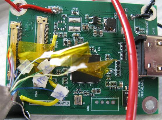 A very very bodged eDP converter bored; there are wires soldered, kaptan tape, small labels.  It's a mess, but it works!