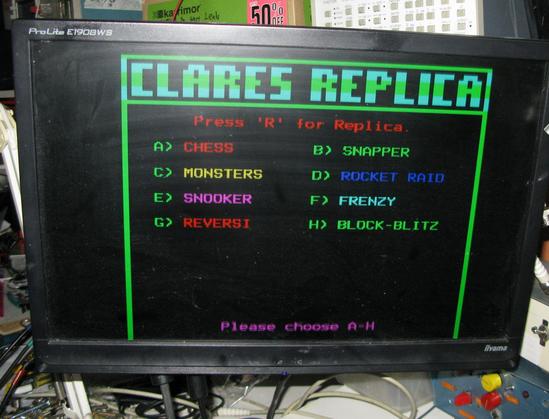 A 'Clares Replica' menu screen on a LCD monitor, showing classic Beeb games like Monsters, Snapper, Rocket Raid, and a few others.