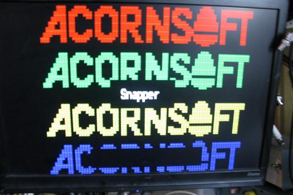 Acornsoft Snapper loading page in Teletext mode showing the Acornsoft logo in red/green/yellow/blue.