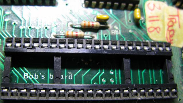 A photo of the CPU socket in a BBC B - a 40 pin DIP, under which is the easter-egg 'Bob's board'