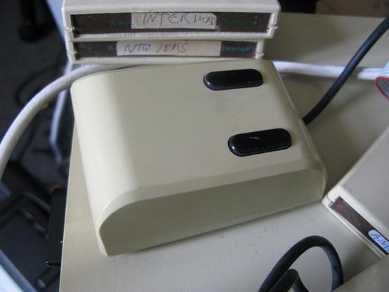 A BBC Master mouse; a small beige mouse with two  long brown/black eyes.